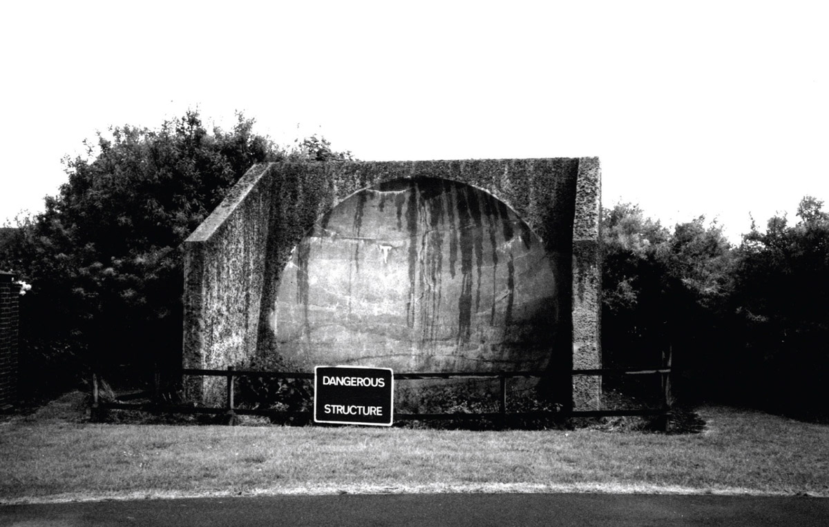 1996 photograph by Julian Hills of the remaining half of a sound mirror at Dungeness.