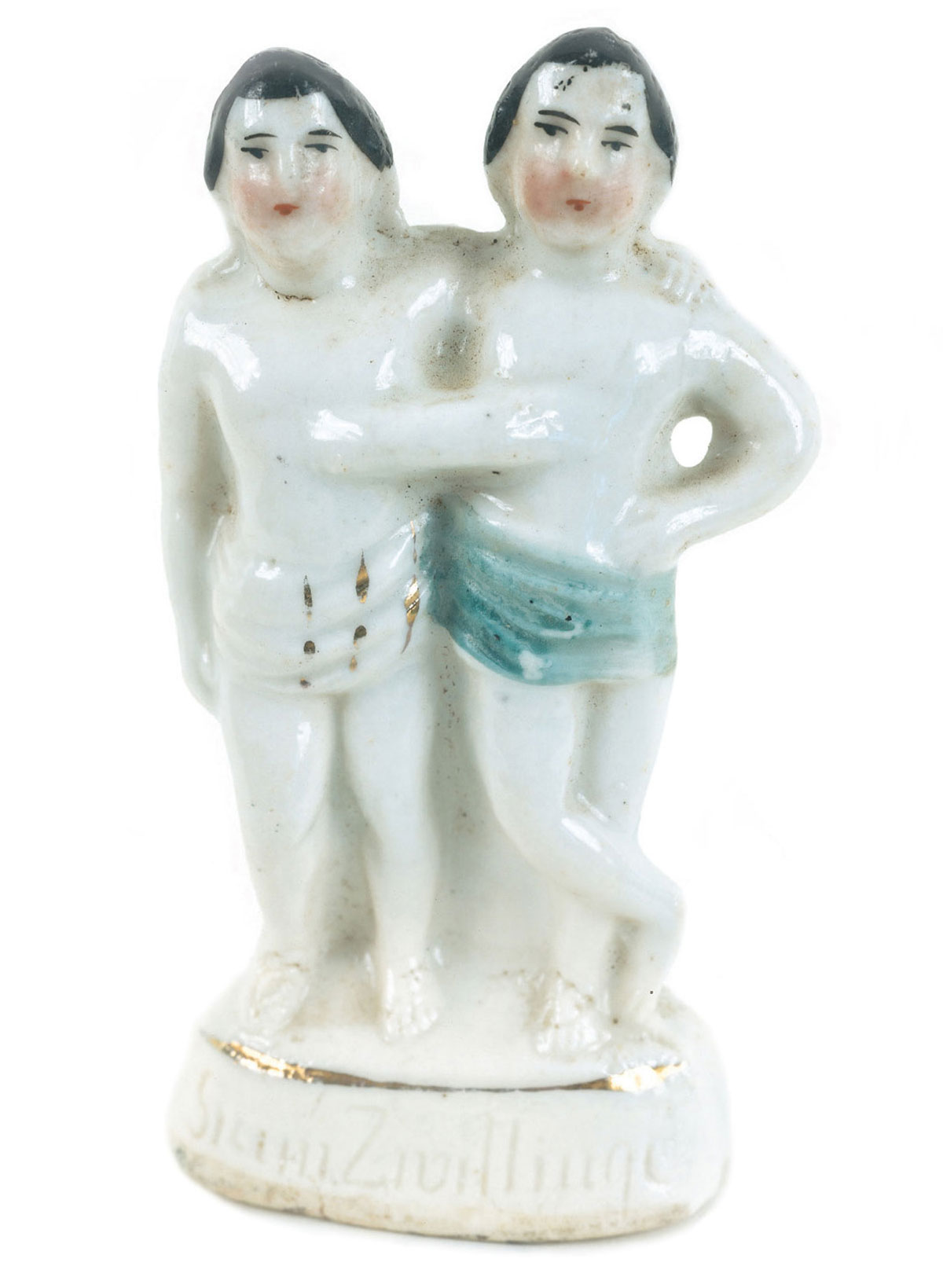 A photograph of a porcelain figurine of the conjoined twins Chang and Eng.