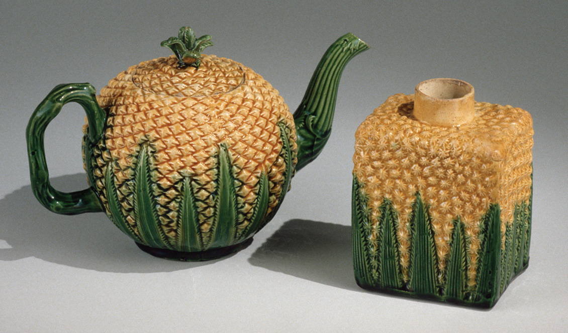 A photograph of a Wedgwood teapot and tea caddy in the form of pineapples, circa seventeen sixty five. 