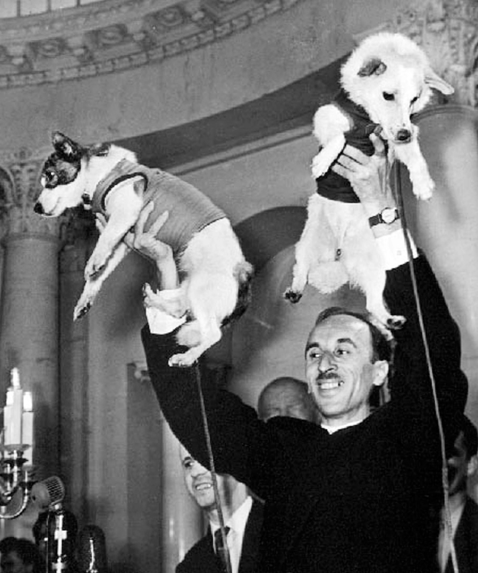 A photograph from the Christ Dubbs collection of Dr. Oleg Gazenko holding dogs Belka and Strelka after their safe recovery from space