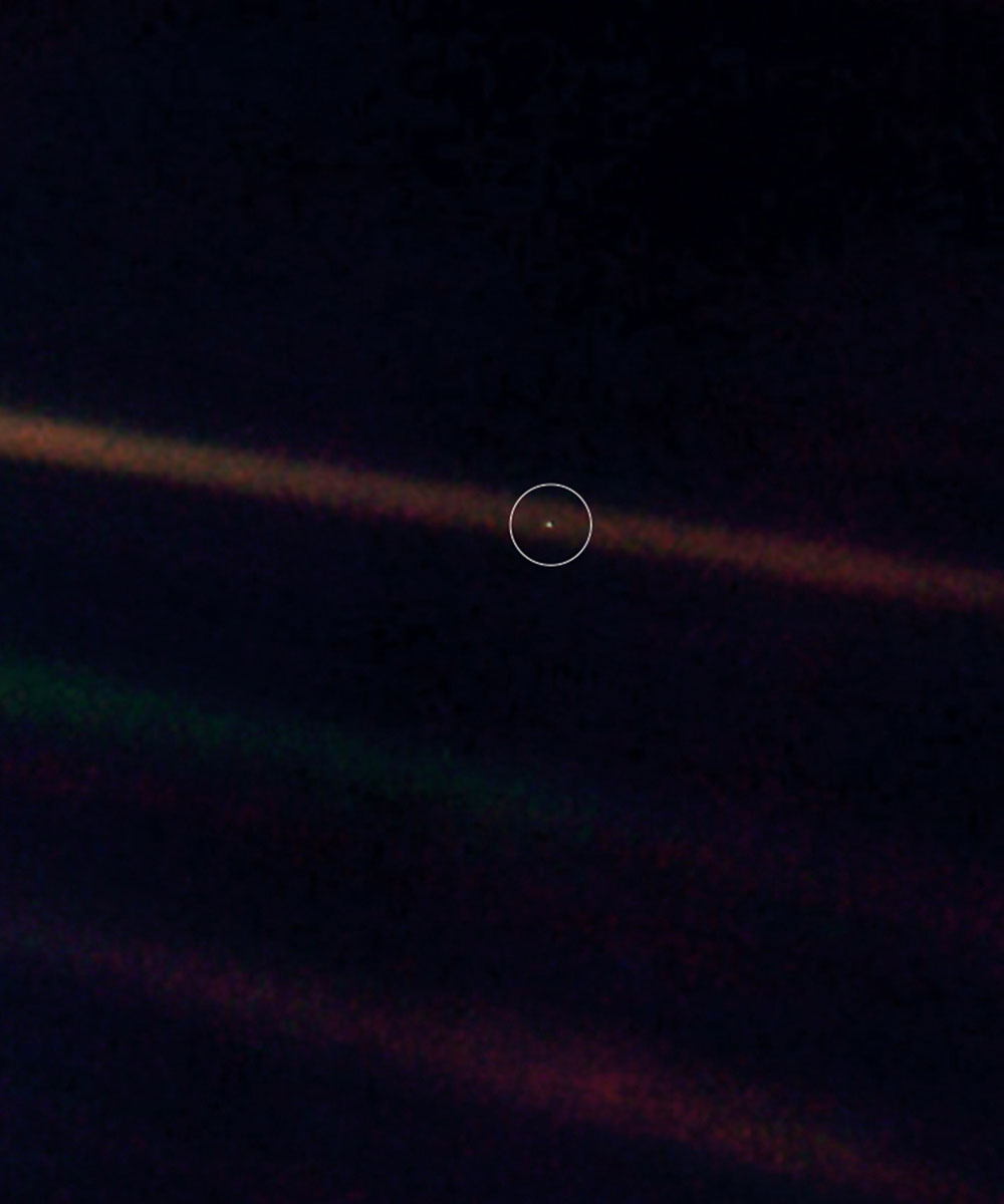 A 1990 photograph taken by Voyager 1 of a barely visible Earth against the vastness of space. The photograph is now known as the “Pale Blue Dot.”