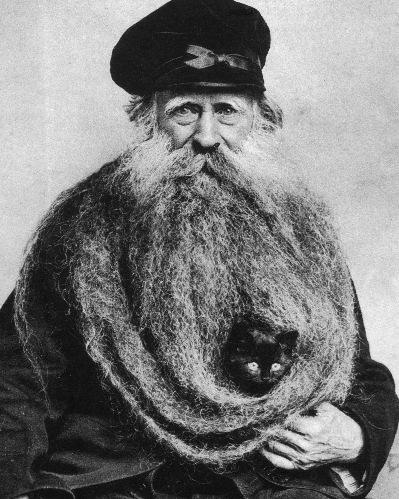 A photograph of French miller Louis Coulon in nineteen oh four, sheltering a kitten in his cozy eleven-foot beard. 
