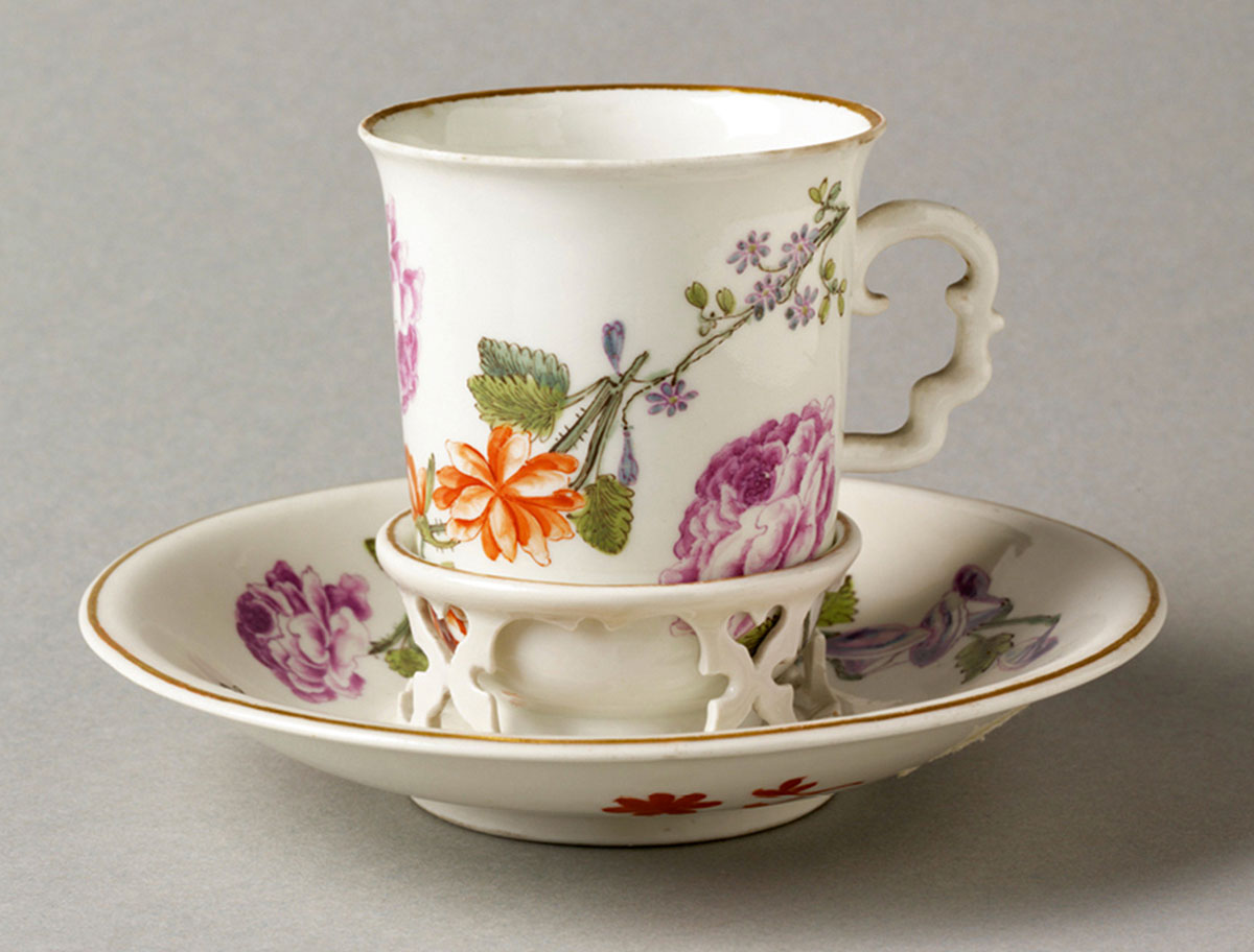 A photograph of a trembleuse cup and saucer, which was produced circa seventeen thirty to seventeen fifty.