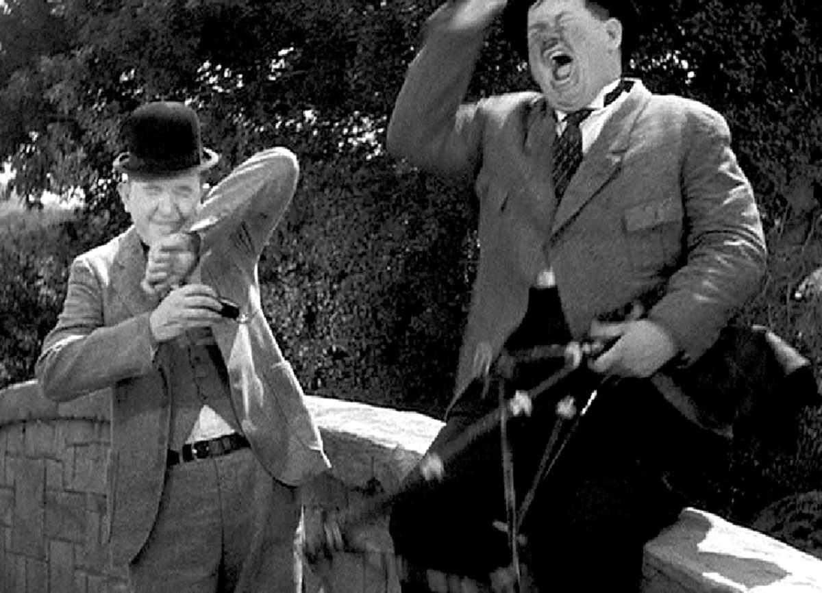 A still of Laurel sneezing into his snuffbox from Laurel and Hardy’s nineteen thirty-five film “Bonnie Scotland.”
