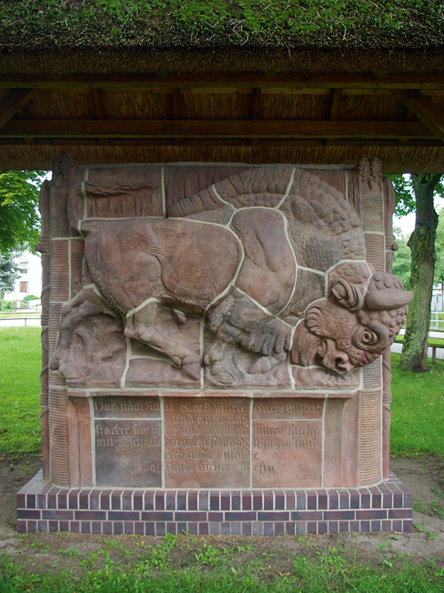 A nineteen thirty-four bison monument by Meissen sculptor Max Esser. Commissioned as a monument to the successful cross-breeding of European bison and Canadian wood bison, it was originally installed on Göring’s Carinhall estate in the Schorfheide Forest. The sculpture was broken into pieces after the war and buried. Unearthed in nineteen ninety, it is now installed in the nearby town of Eichhorst.