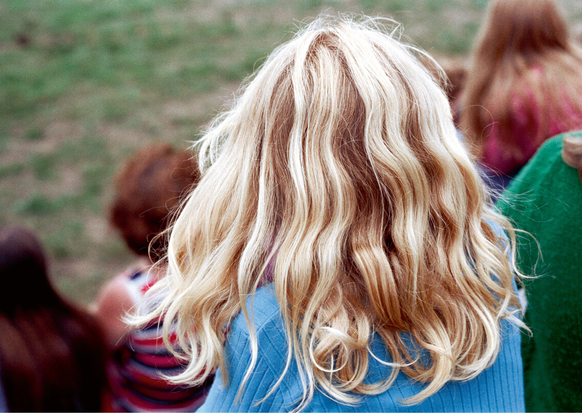 Nick DeWolf’s photograph of the back of a blonde child’s head. 