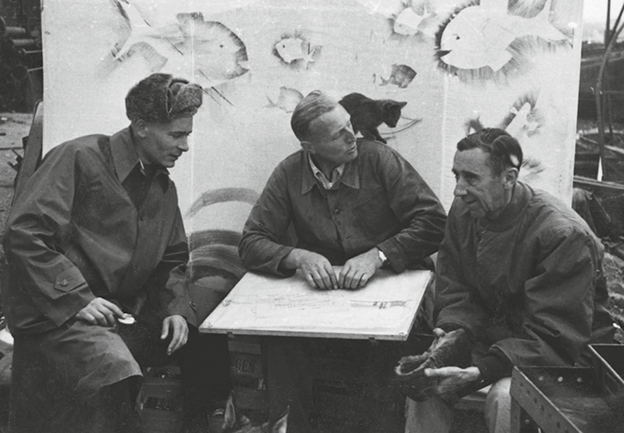 A photograph of Sellner and Tailliez enjoying the company of one of the many cats that assisted on the project.