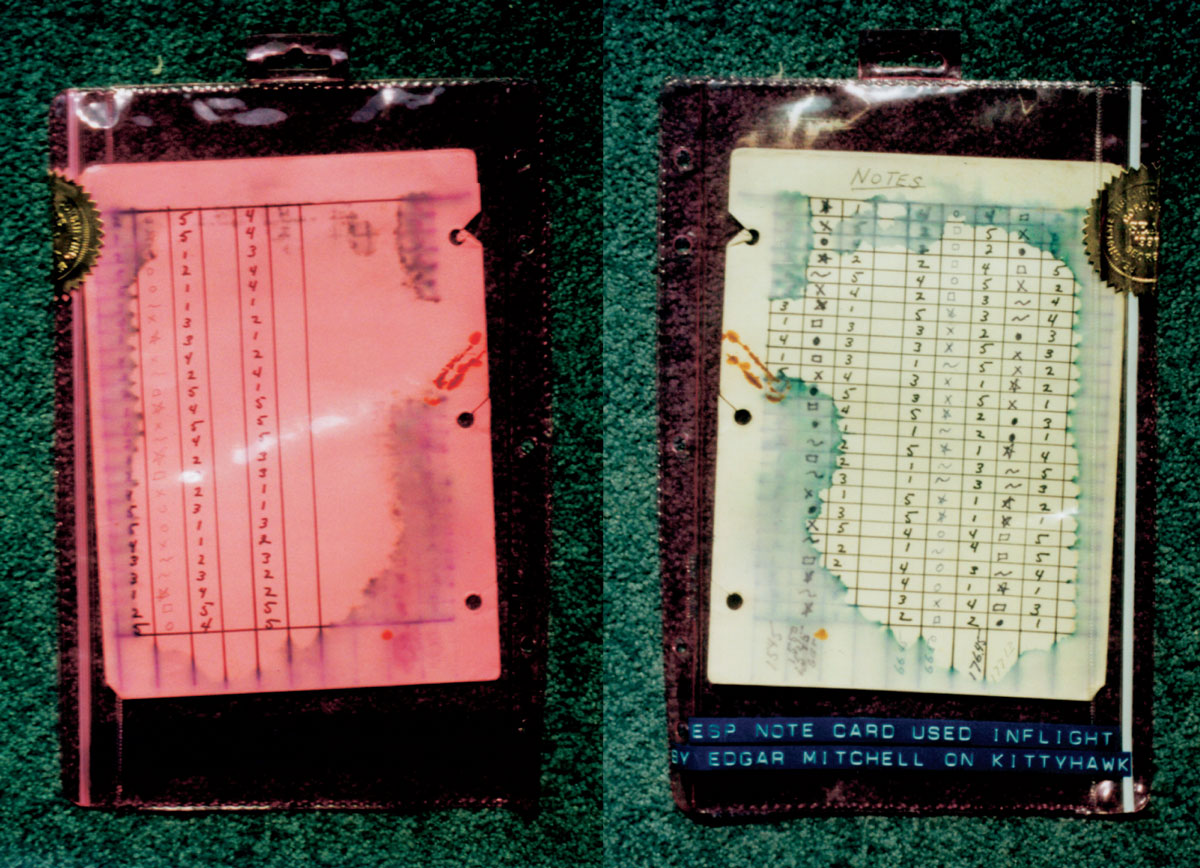 Two photographs of ESP log cards in translucent vinyl cases against a green background. These cards were used by Edgar Mitchell while traveling to the moon.