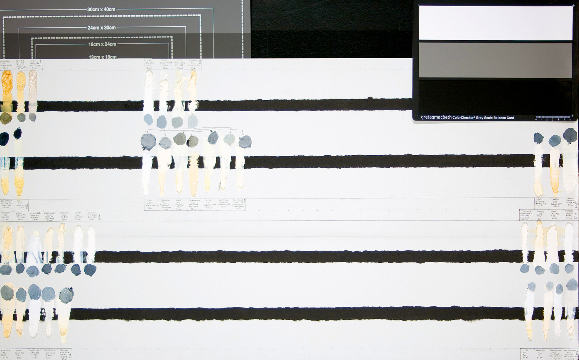 A photograph of a page of white paint swatches, from Jonathan Linton‘s research into how various white oil paints fade over time.