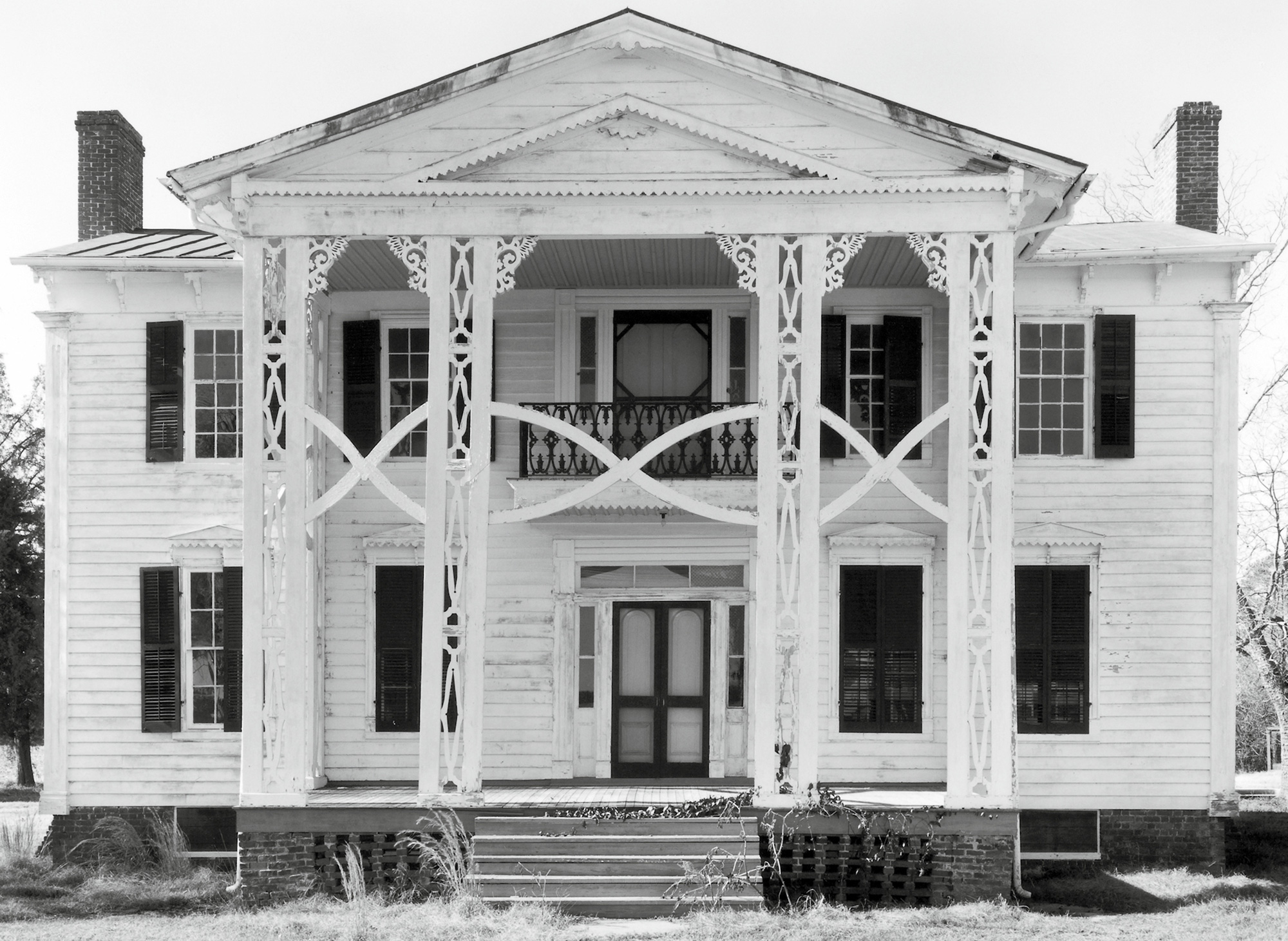 Max Belcher’s nineteen eighty-six photograph titled “House” of a dilapidated stately home built in circa eighteen twenty in Northampton County, North Carolina.