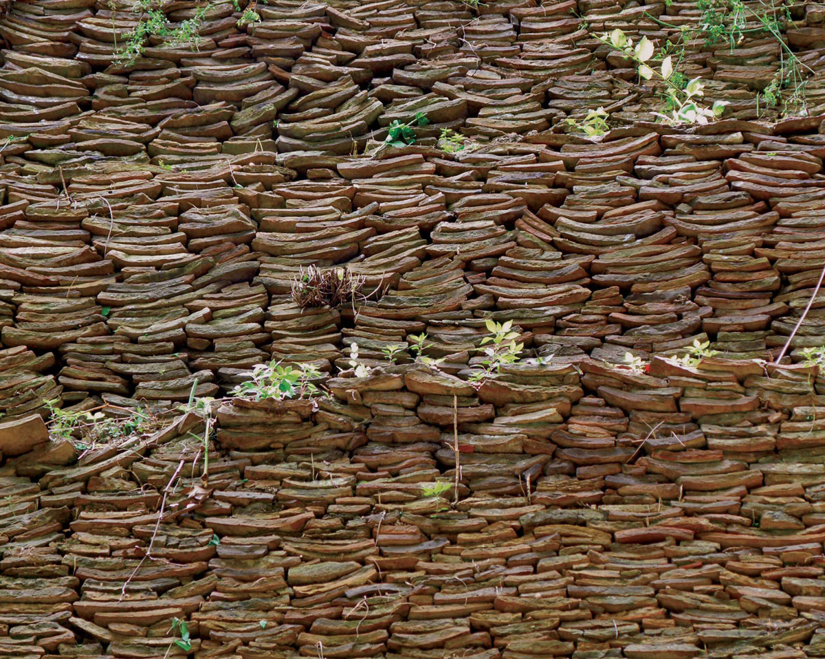 A photograph of amphorae shards piled to form terraces at Monte Testaccio.