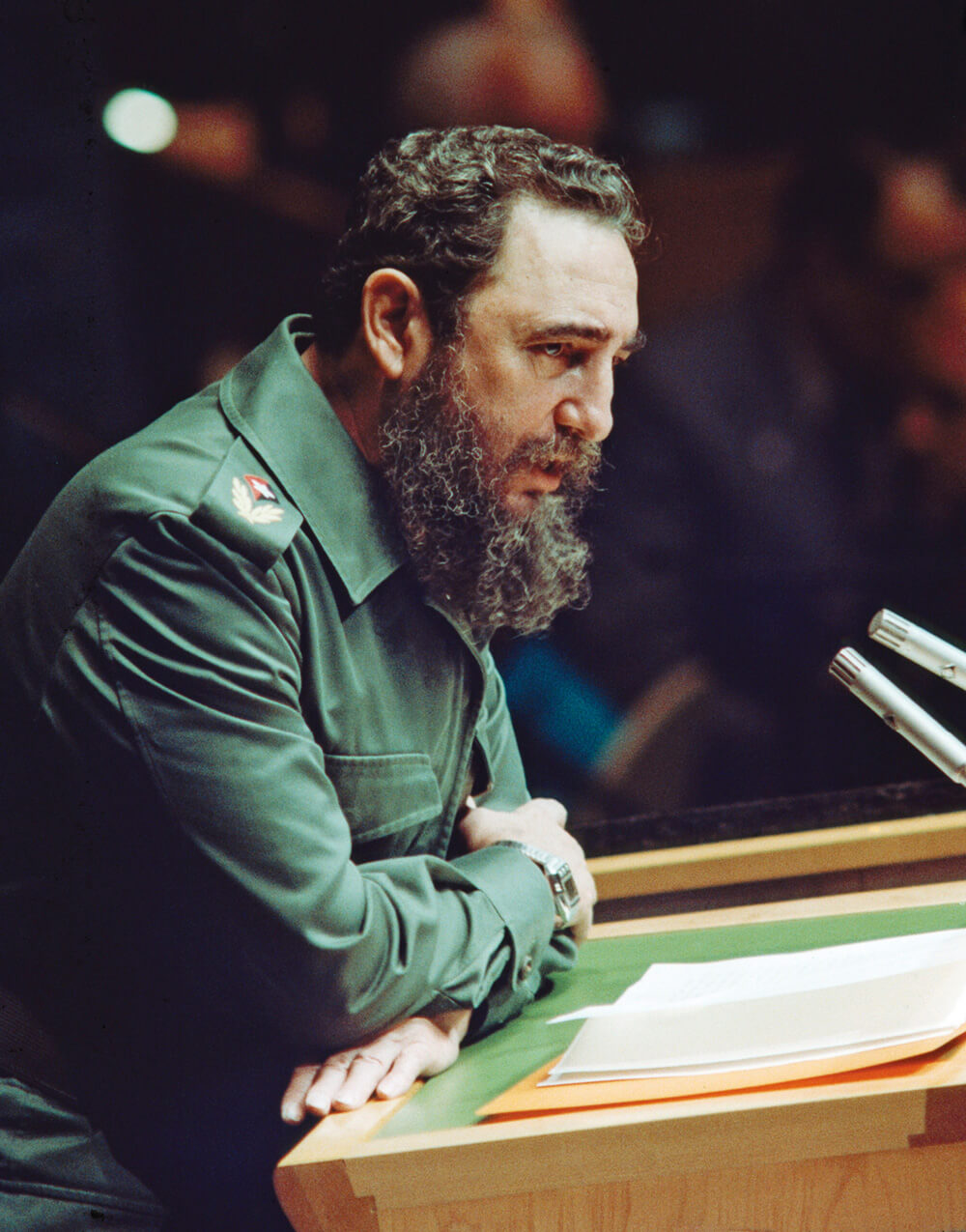 A photograph of Fidel Castro wearing his iconic army green uniform, addresses the United Nations on the 12th of October nineteen seventy-nine.