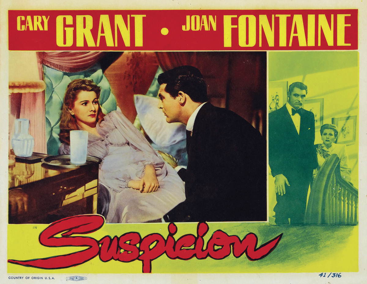 A nineteen forty one lobby card for Alfred Hitchcock’s “Suspicion,” depicting Cary Grant sitting beside Joan Fontaine in bed, with a glass of milk on the bedside table. 
