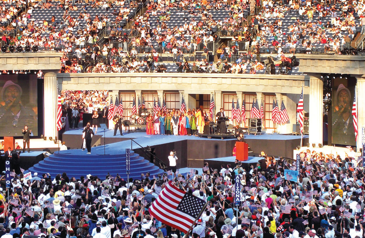 A photograph of singer Will I Am performing at the two thousand eight Democratic National Convention in Denver, Colorado.  