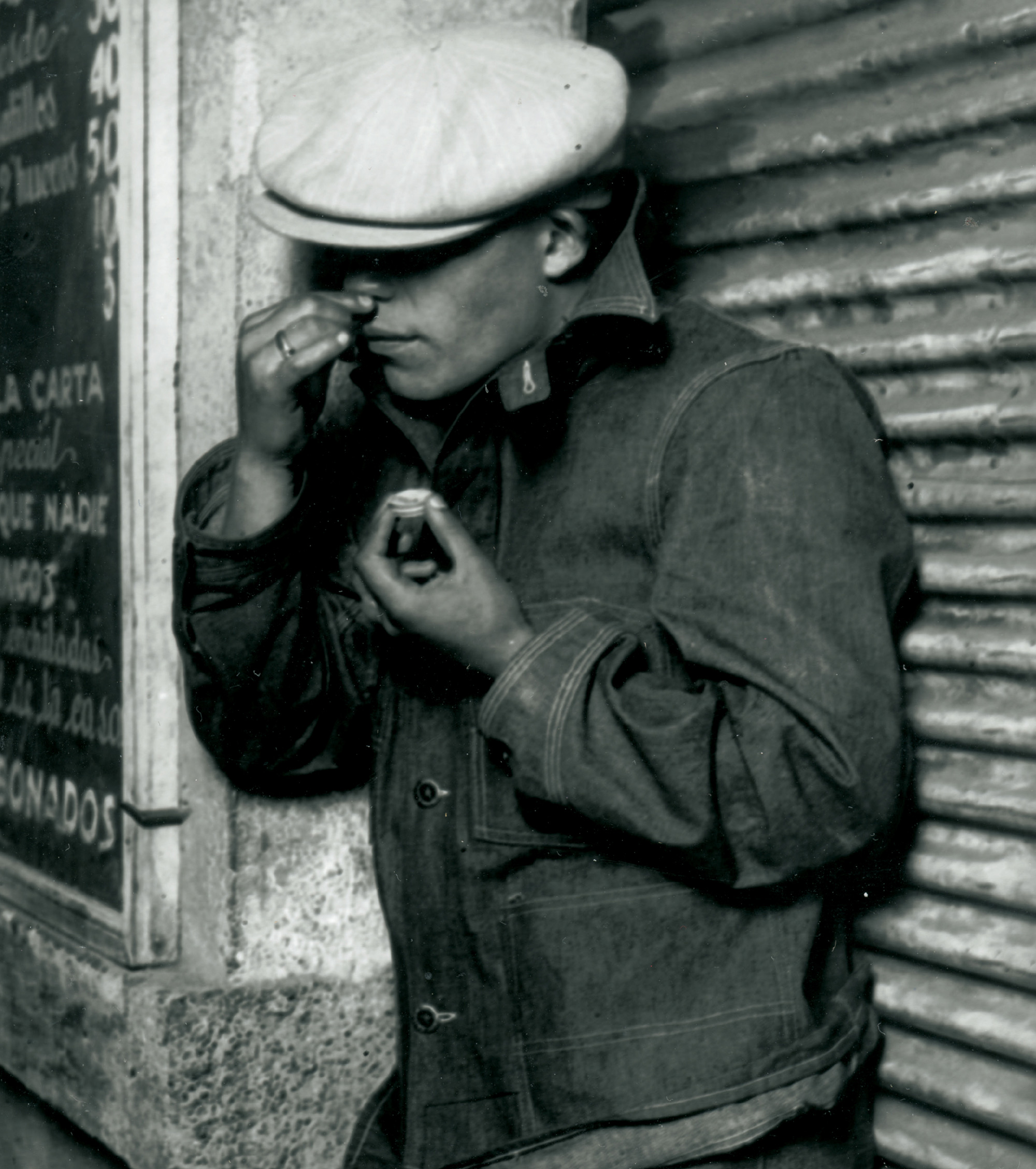 A photograph from the 1920s or 1930s depicting a man snorting a drug.