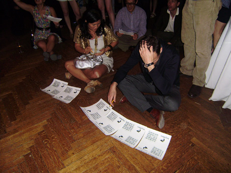 Hesu Coue-Wilson and Edward Wilson poring over their bingo cards in their quest to win the Spencer Finch photograph.