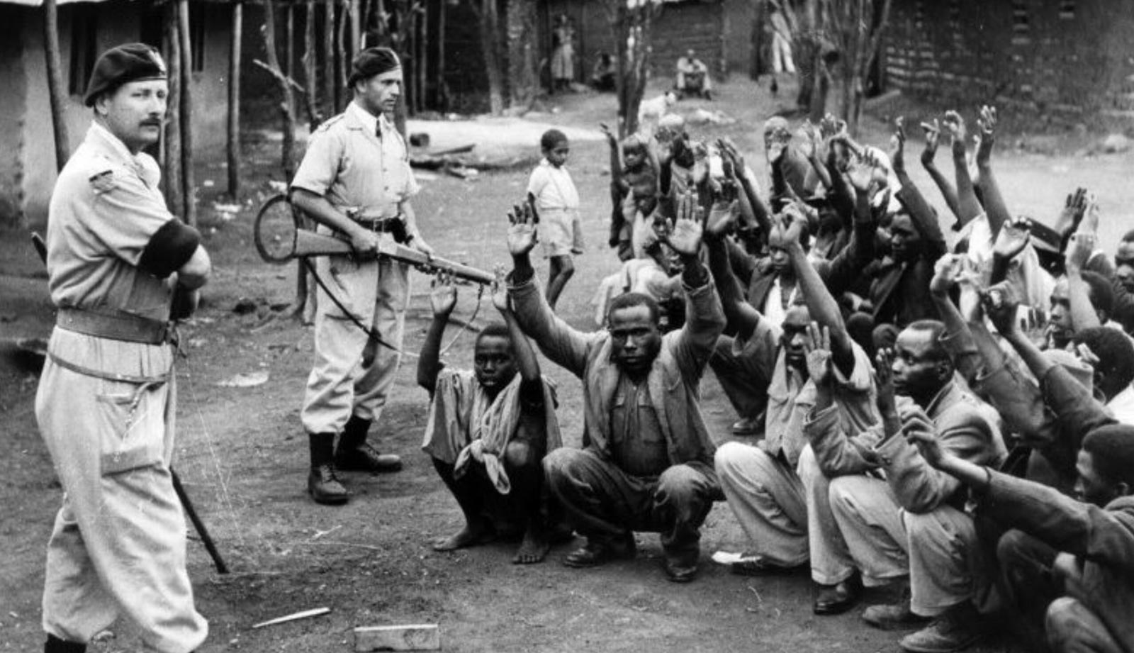 British police guarding Kikuyu participants suspected of involvement in the Mau Mau uprising, Kenya, 1953.