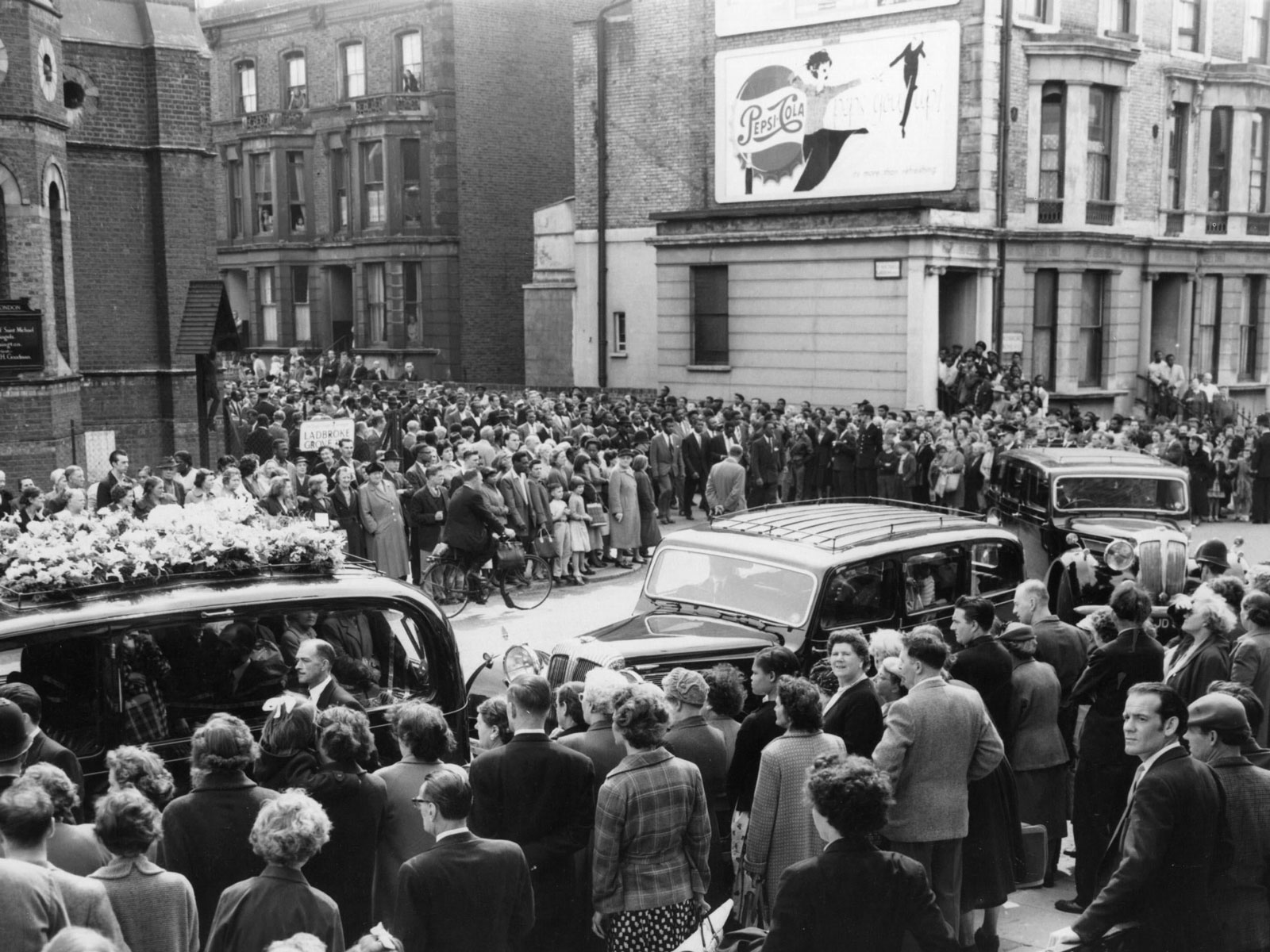 Crowds lined along Ladbroke Grove for the funeral of Kelso Cochrane, Notting Hill, London, 6 June 1959. Cochrane had been murdered by a group of white youths in the early hours of 17 May.