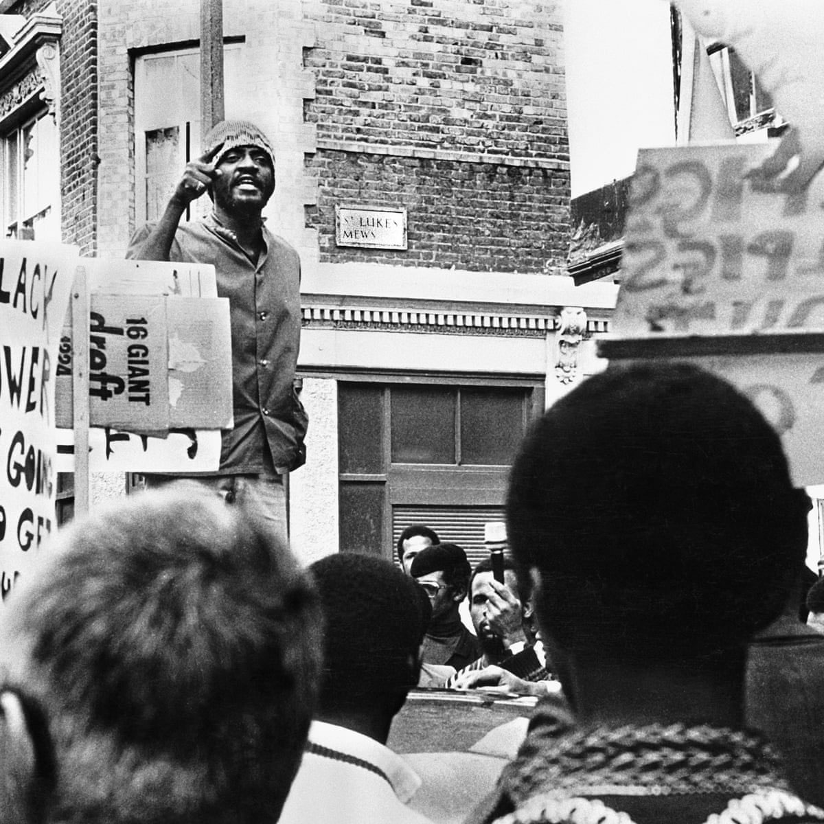 Civil rights activist Darcus Howe addressing a rally for the Mangrove Nine in Notting Hill, London, 1971. Howe, one of the Mangrove Nine, was charged with “incitement to riot” following a protest on 9 August 1970 against the police’s continuous harassment of the restaurant and its owner Frank Crichlow. All nine were acquitted of this charge in the trial at the Old Bailey, which ended in December 1971. Photo Horace Ové.