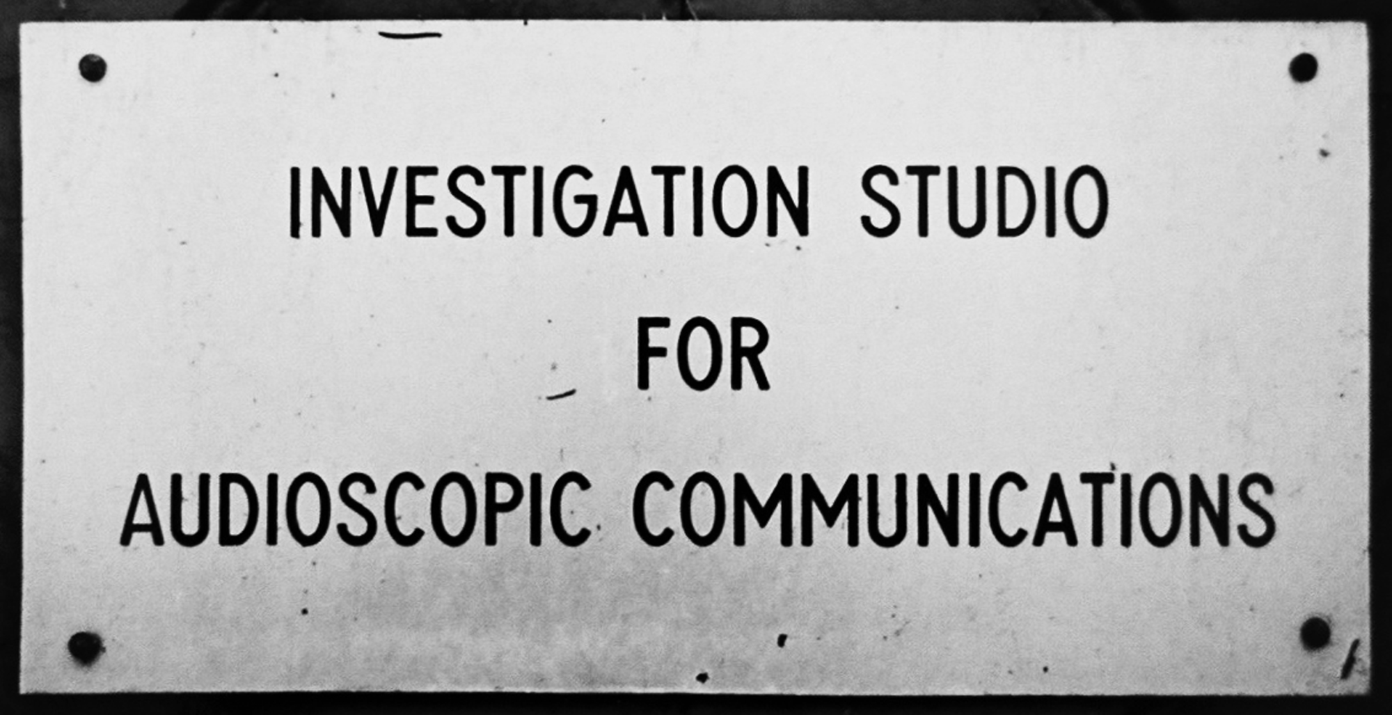 A sign reading “Investigation Studio for Audioscopic Communications.”