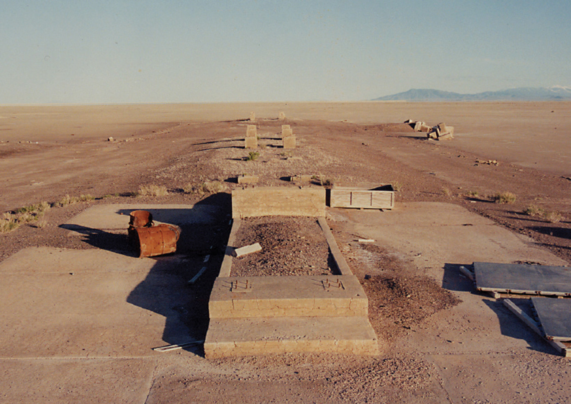 A photograph of a cement launch ramp ruin in the desert.
