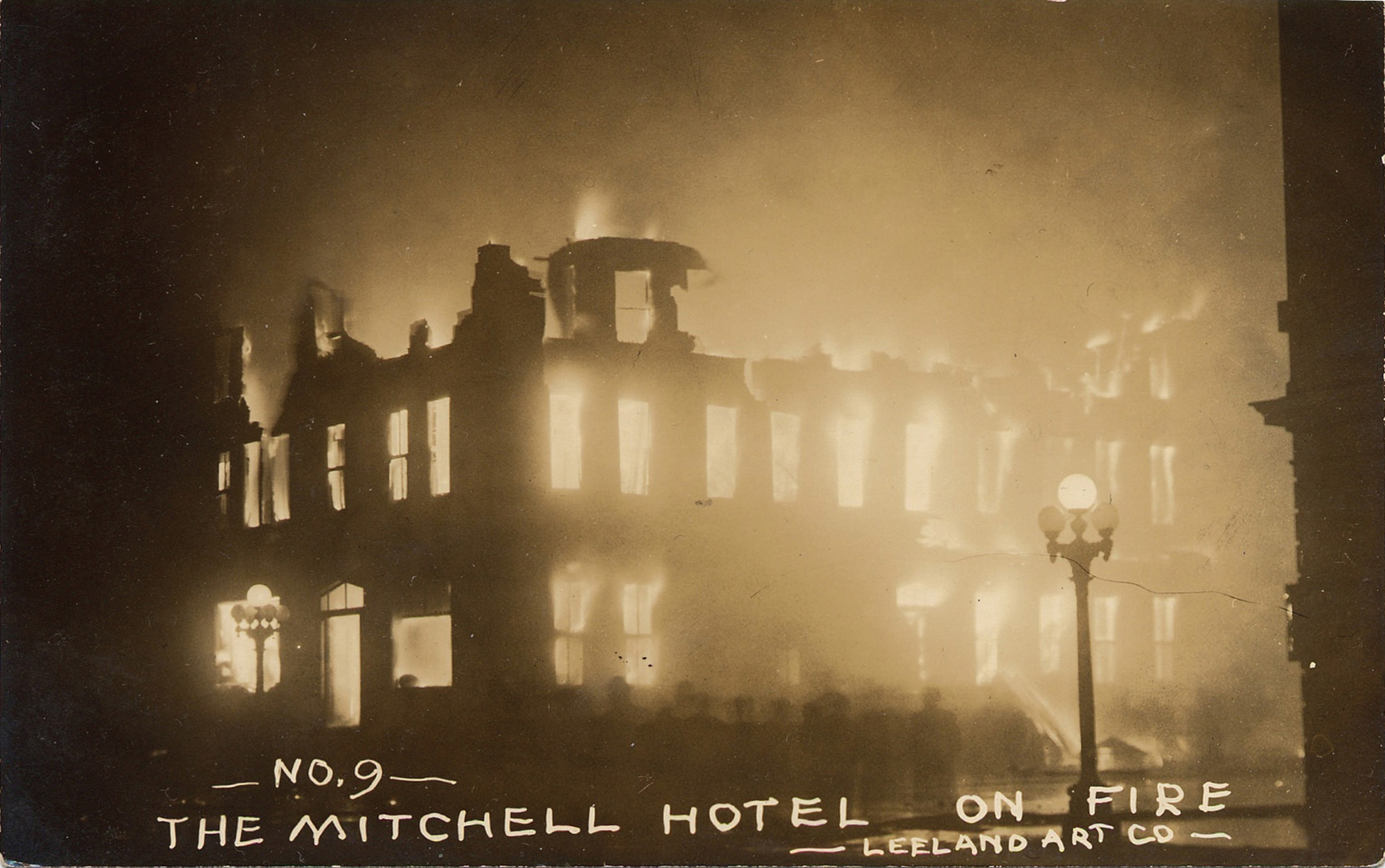 Sepia photograph of the Michell Hotel on fire.