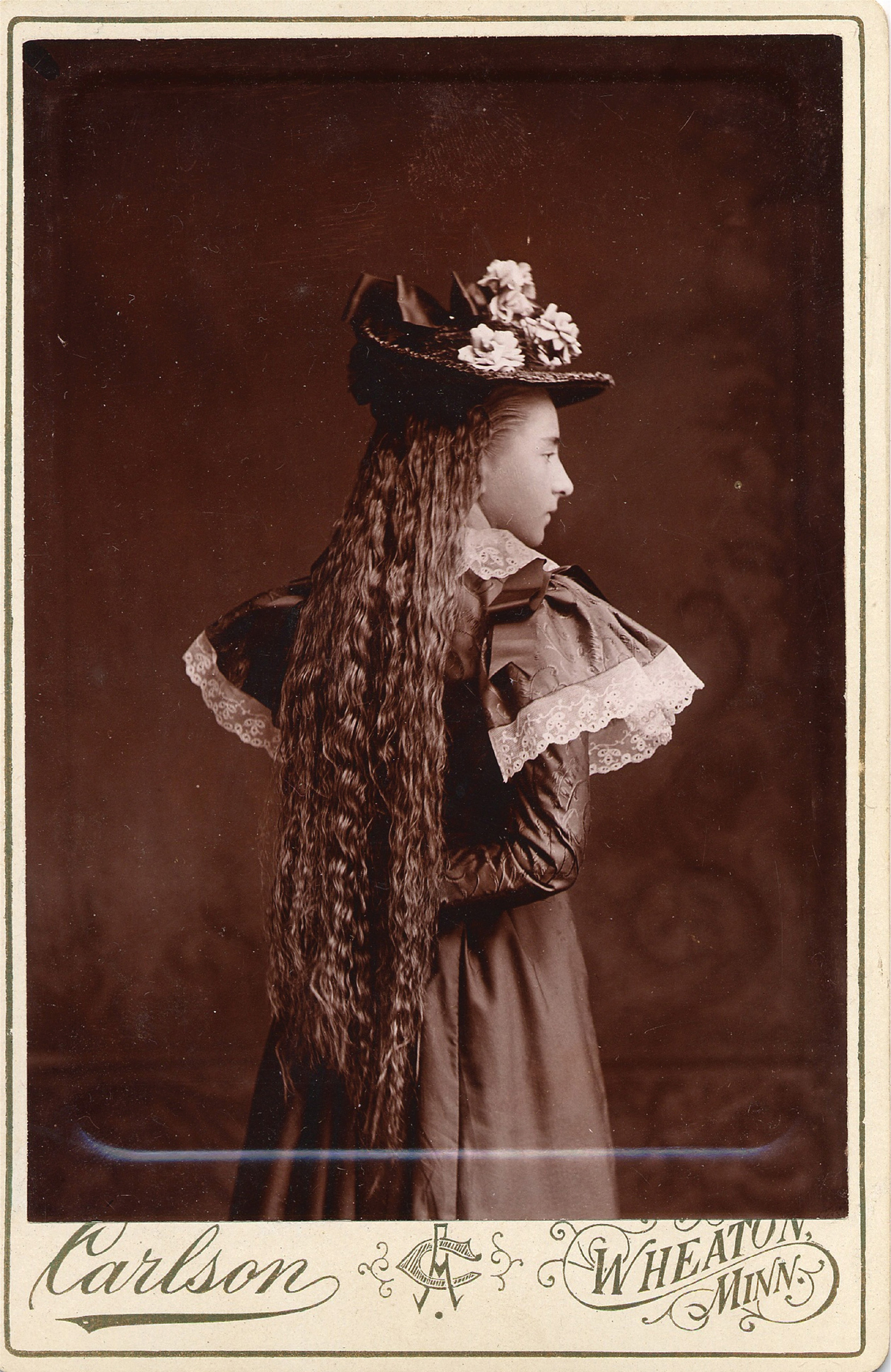 Sepia photograph of girl posed in costume, Wheaton, Minnesota.