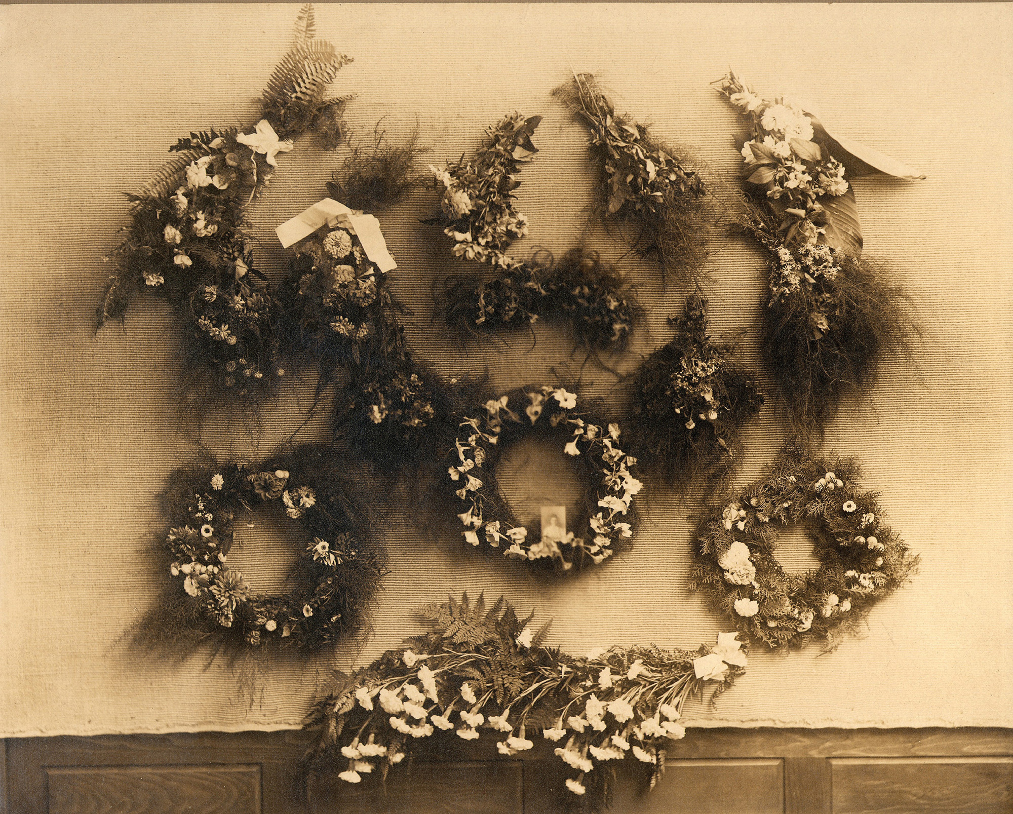 Sepia photograph of floral wreaths.