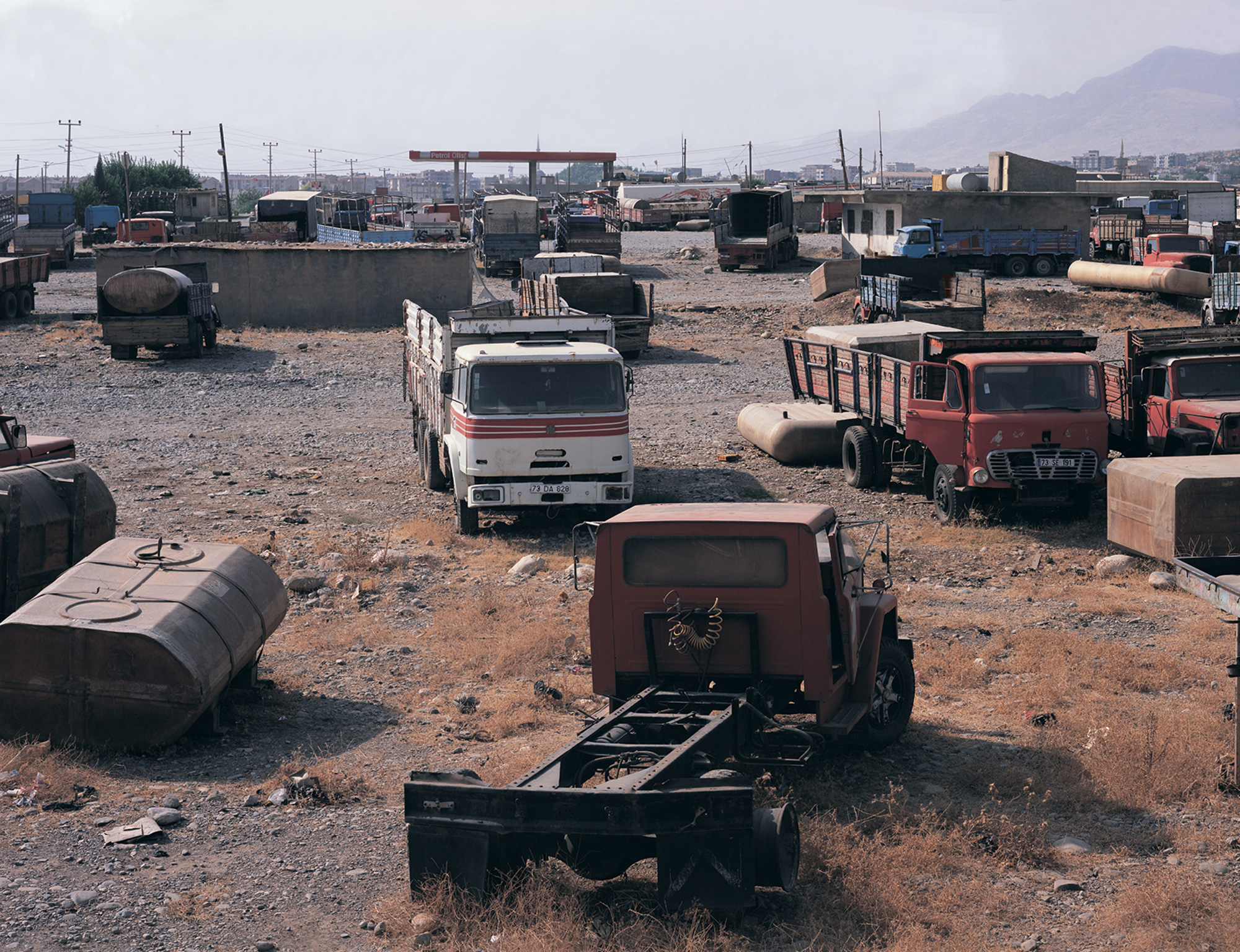 A photograph of trucks in dumping ground at Turkey-Iraq border on the outskirts of Silopi near Sirnak, 9 August 2003.