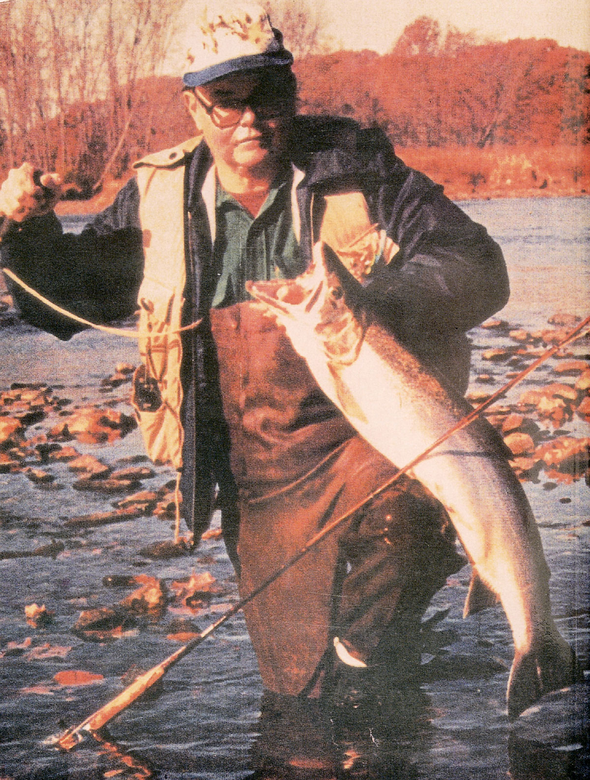 A photograph of Fran Betters holding up a large, newly caught fish.