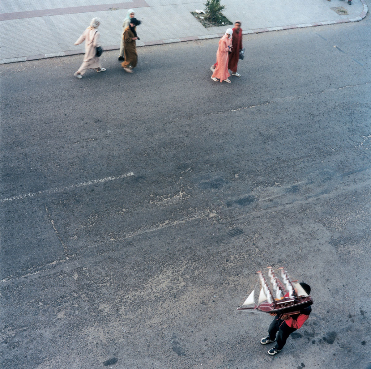Artist Yto Barrada's 2000 photograph of figures walking through Tangier's Boulevard Playa, titled 