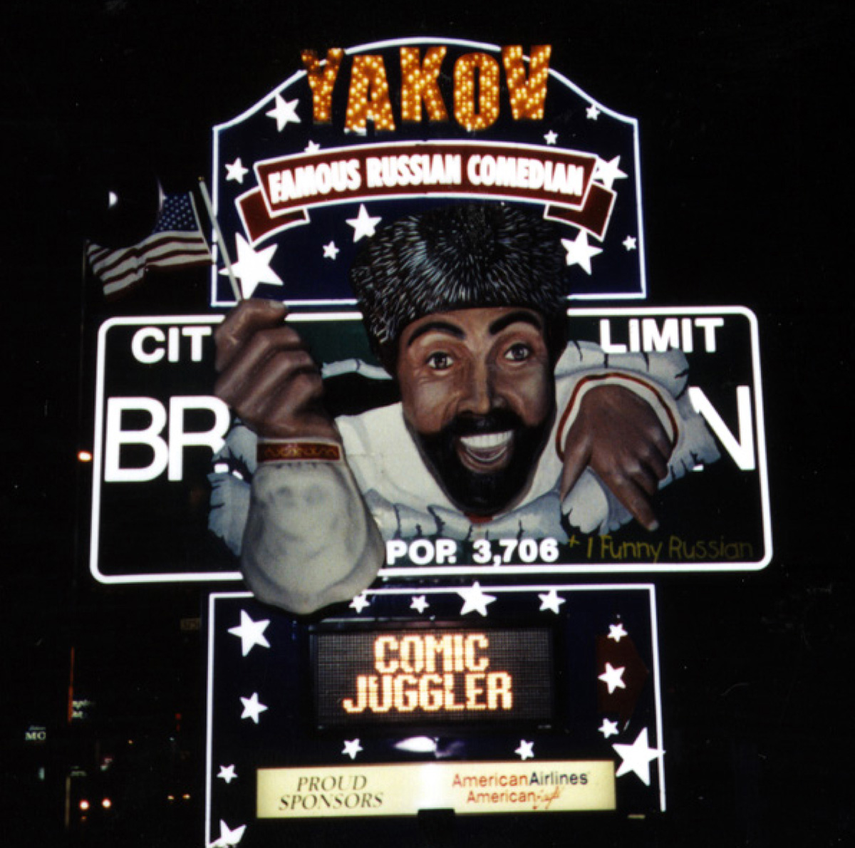 A photograph of a lighted sign in Las Vegas advertising a show by the comedian Yakov Smirnoff.