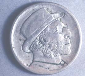 Nickel with a hand-carved engraving of a man wearing a hat.