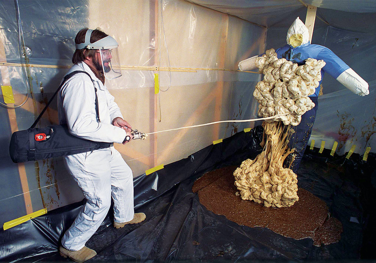 A researcher testing sticky foam on a dummy.