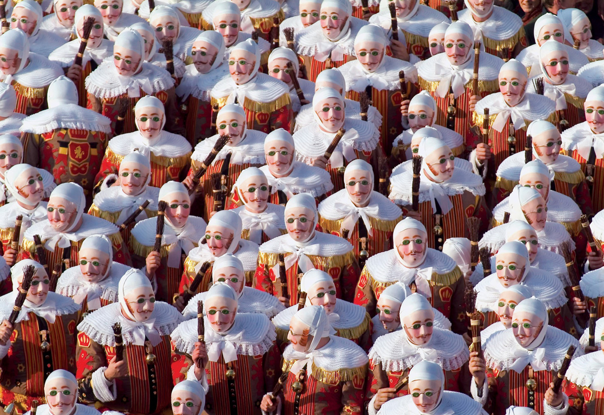 A two thousand four photograph of men dressed as Gille, the principal character of the Carnival in Binche, Belgium.