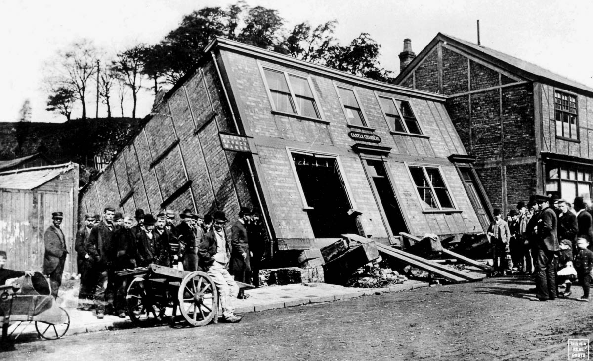 A photograph of offices on Castle Street, Northwich, leaning backwards and almost toppling over as a result of subsidence from the salt mine beneath, eighteen ninety one. 