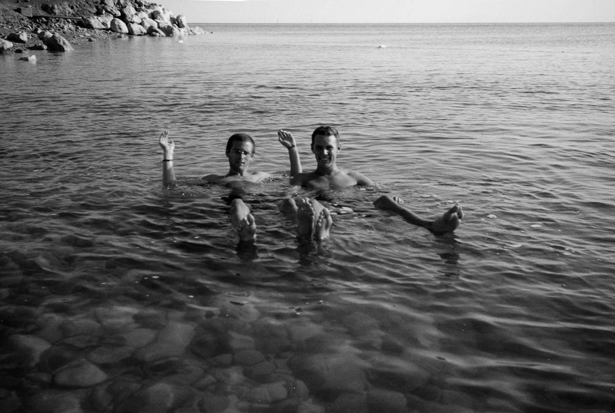 A photograph of two men floating in the the Dead Sea, nineteen ninety five. 