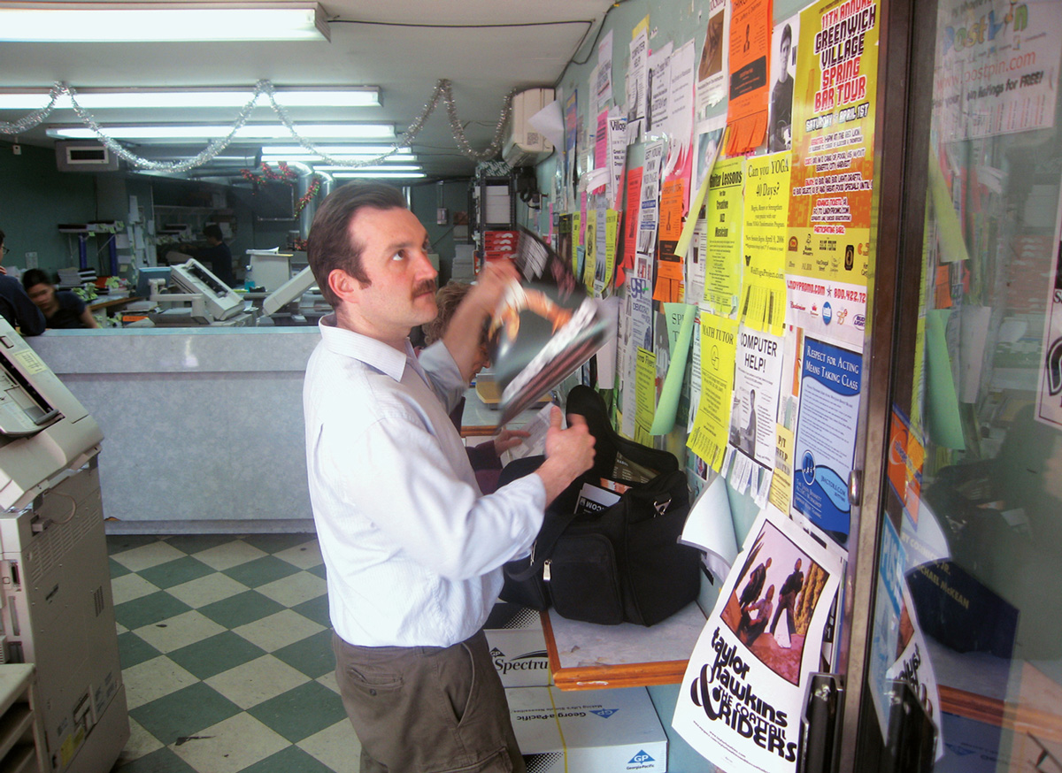 A photograph of Coelius performing his role as a poster distributor.
