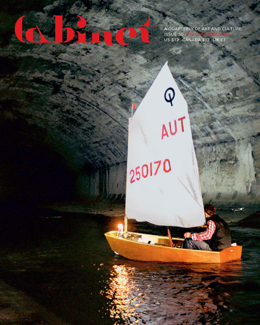 Still from artist Hans Schabus’s 2002 video Western. Depicted is a man in a small sailboat with raised sails drifting through a tunnel in Vienna’s sewer system. 