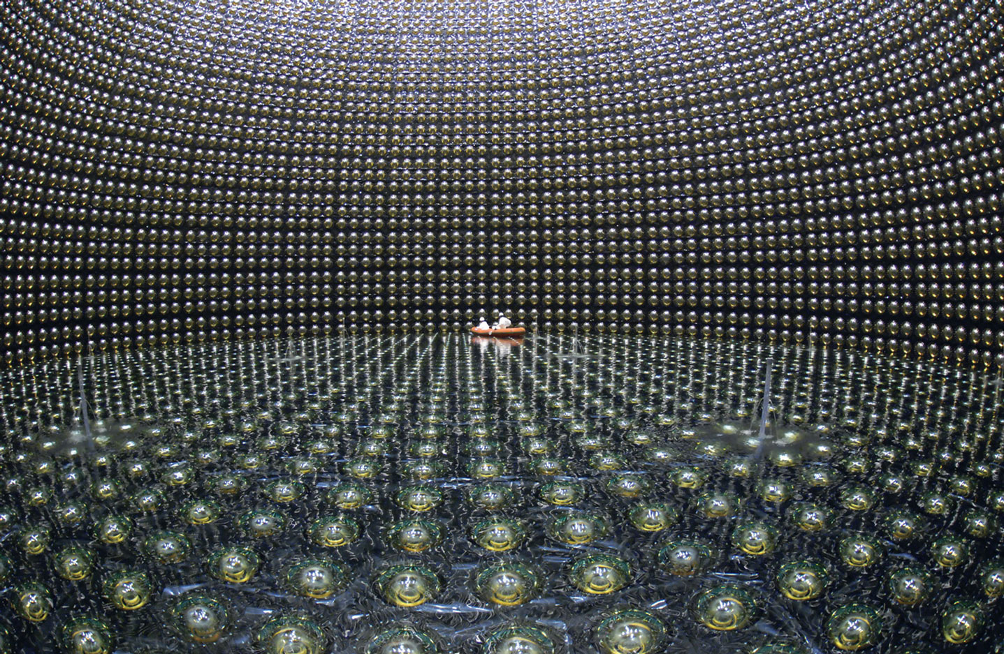 A photograph of a 50,000-ton water Cerenkov detector used for the University of Tokyo’s Super Kamioka Neutrino Detection Experiment. The observatory is a kilometer underground in a former mine located in Kamioka-cho, Gifu, Japan. 