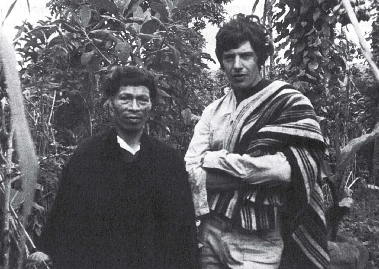 A photograph of Michael Taussig in a garden with yagé vines with Don Pedro, an Indian healer. Colombia, nineteen seventy-seven.
