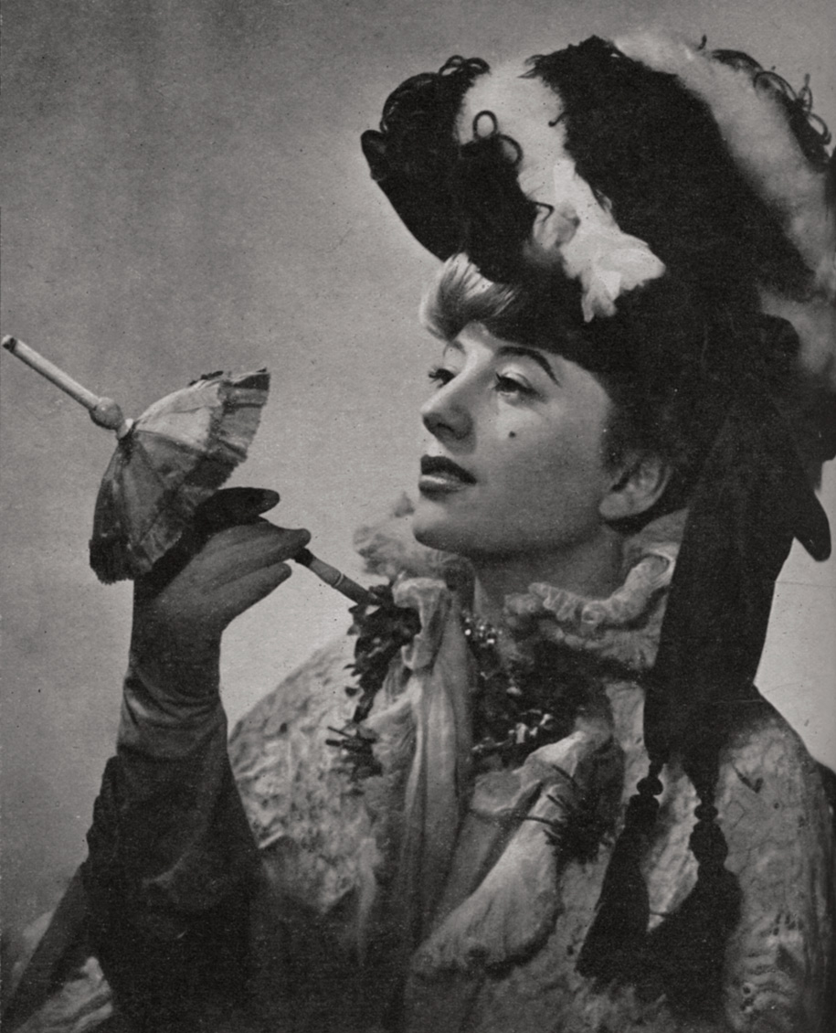 The singer Lilli Bontemps demonstrating a miniature parasol cigarette holder, ca. 1940s.