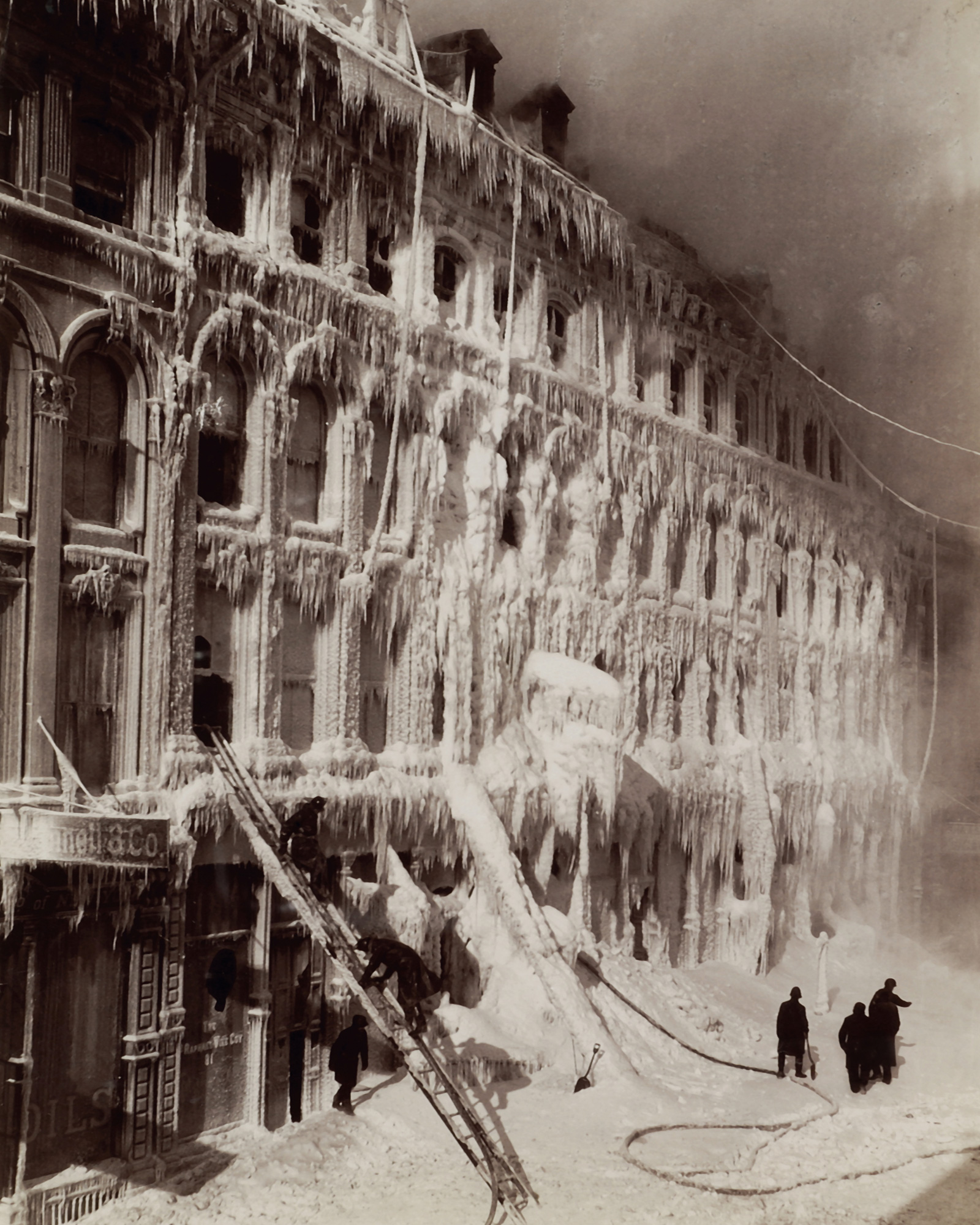A photograph of a building encased in ice after a fire, 65–83 Little St. James Street, Montreal.