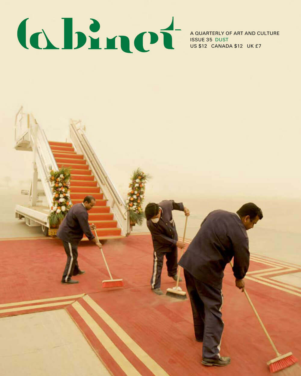 A 2009 image of Kuwait International Airport employees sweeping the red carpet during a sandstorm in preparation for the arrival of French president Nicolas Sarkozy.
