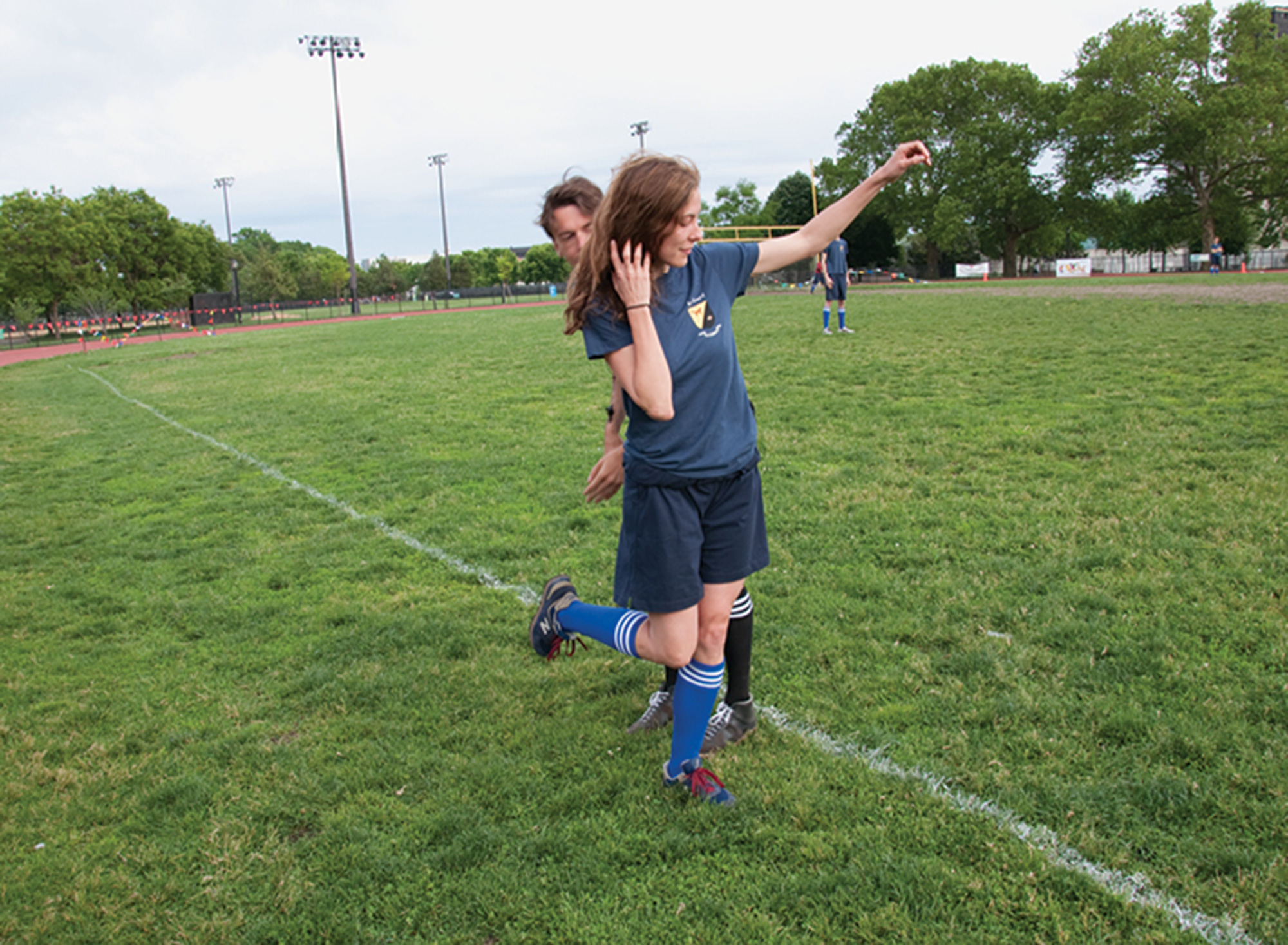 A photograph of Claire Lehmann getting her cleats checked before she runs on as a substitute.