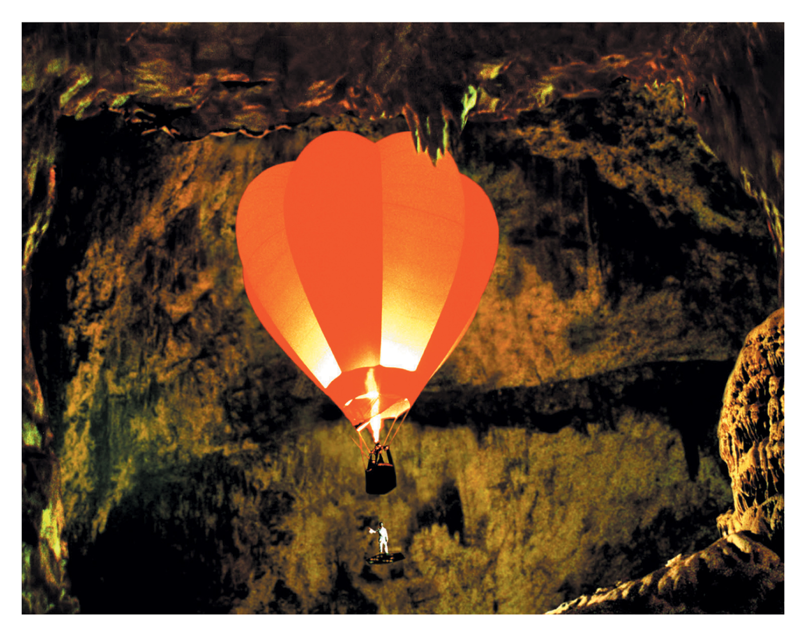The front of this issue’s postcard by artist Vadim Fishkin titled “Air Balloon in the Cave” depicting a hot air balloon being flown inside the Postojnska Jama cave in Slovenia.