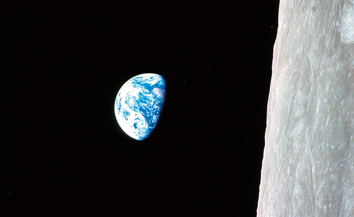 “Earthrise,” photographed by Apollo 8 on 12 December 1968. According to NASA, “this view of the rising Earth … is displayed here in its original orientation, though it is more commonly viewed with the lunar surface at the bottom of the photo.” 