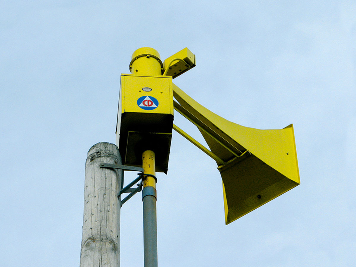 The United States Civil Defense symbol on the side of a Thunderbolt one-thousand-and-three siren.