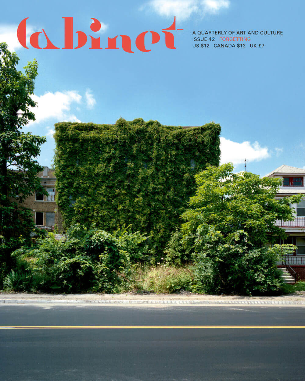 Artist Kevin Bauman’s photograph titled East Side Apartment depicting a Detroit apartment building whose façade has been completely overtaken by vegetation.