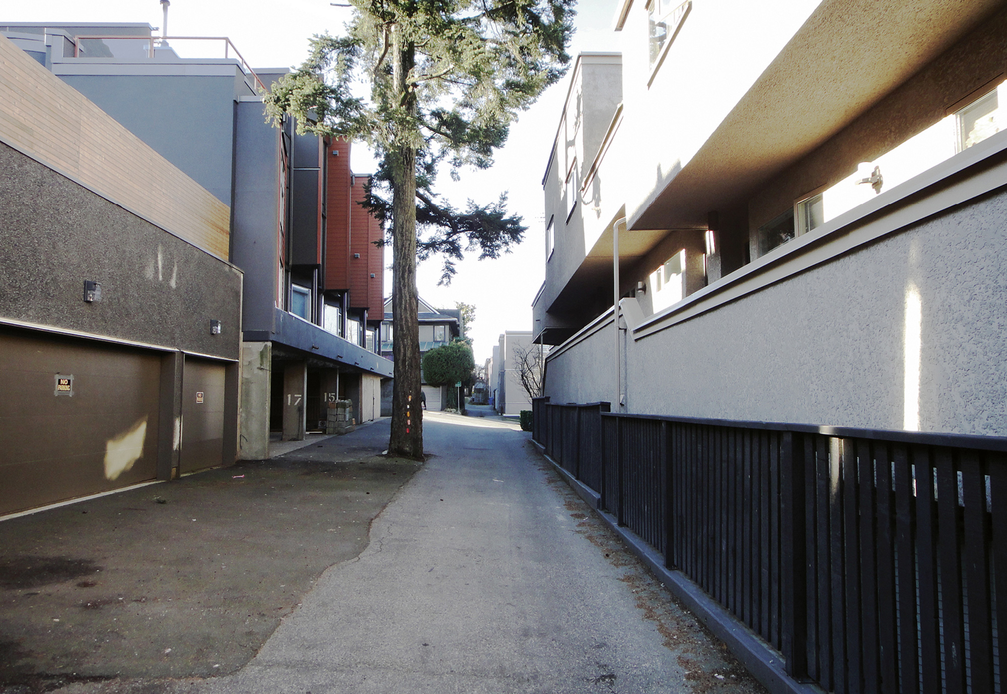 A photograph titled “Roundabout Vancouver: Laurel Lane at West Eighth Street, circa twenty ten.” It shows a quiet alleyway.
